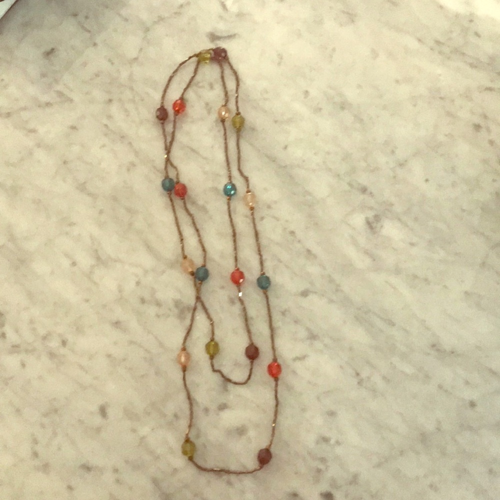 Long continuous beaded necklace.